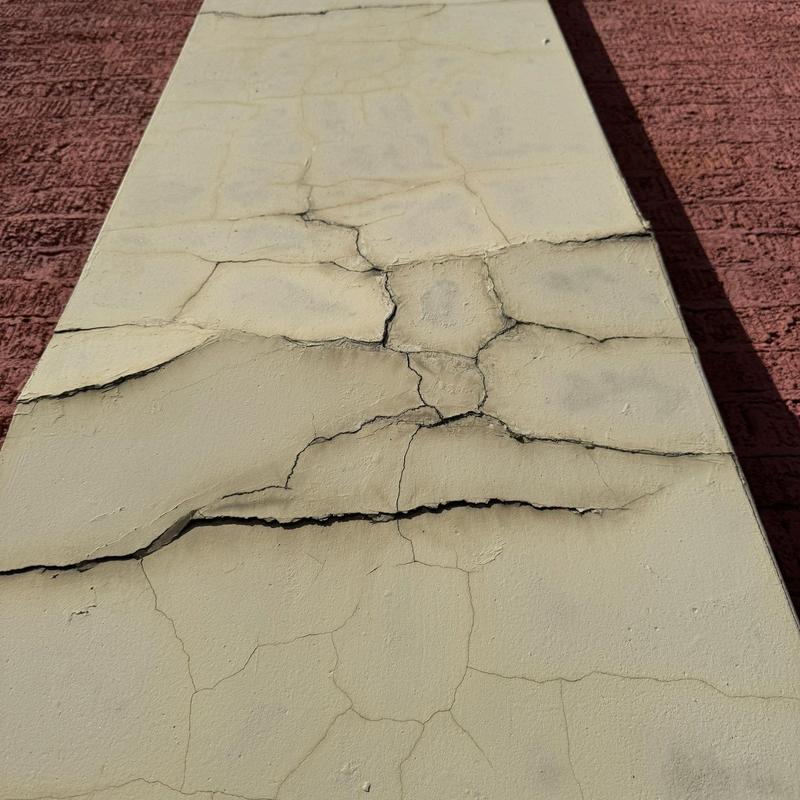 Stucco wall with extensive cracks and damage Stucco wall with extensive cracks and damage