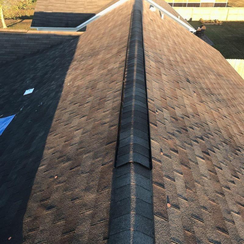 Asphalt shingle roof with ridge cap and valley reinforcement