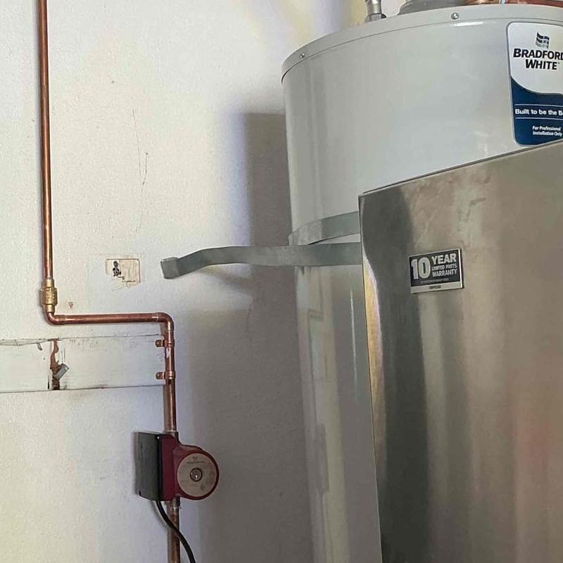 Water heater recirculating pump with check valve installed