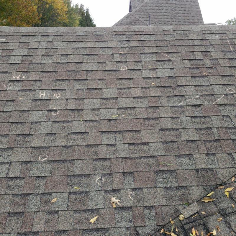 Asphalt shingle roof with hail damage markings