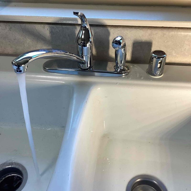 Kitchen faucet with running water and sprayer handle