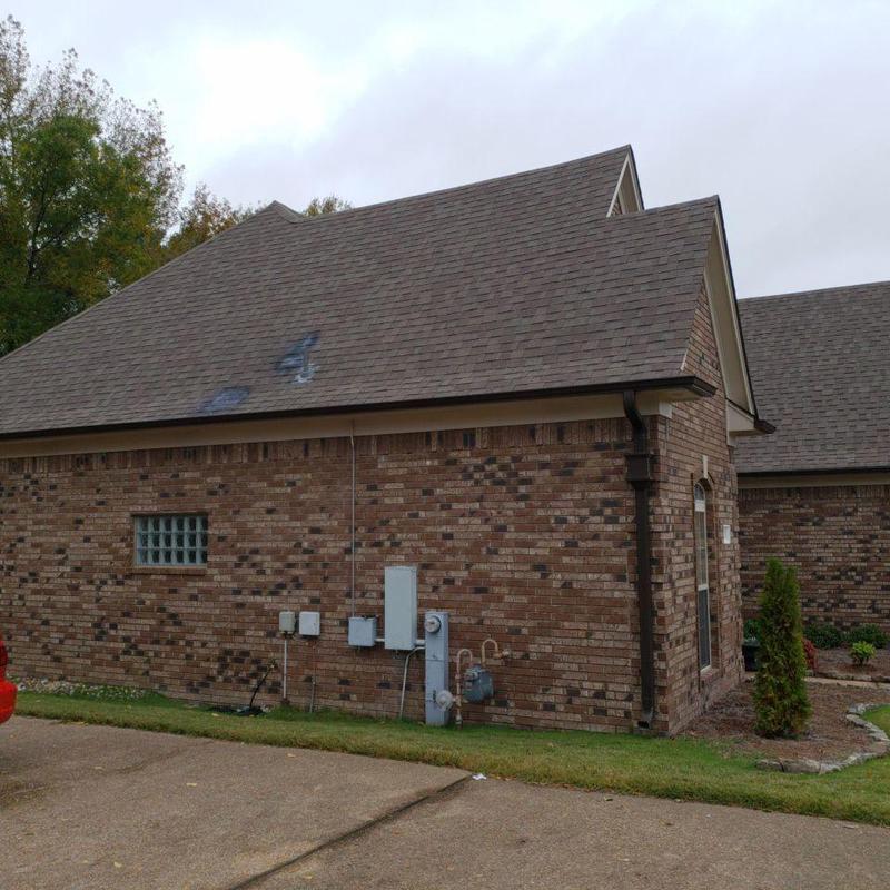 Shingle roof with ridge cap on brick home