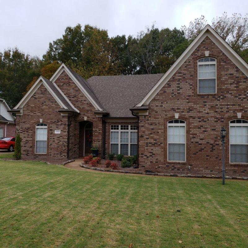 Shingle roof with ridge cap on brick home