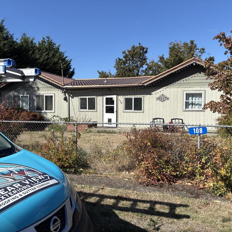 New gutters on residential roof with solar panels