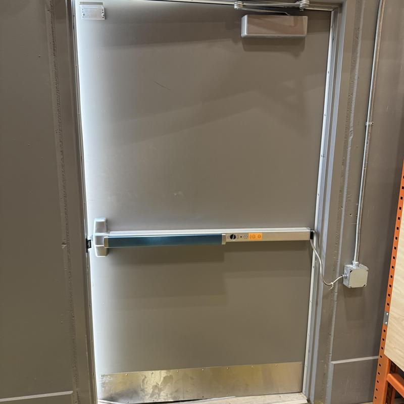 Panic bar exit device installed on steel door