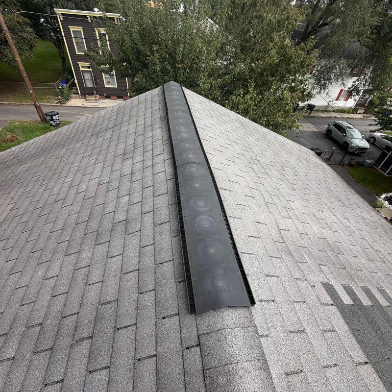 Ridge vent on grey architectural shingle roof Ridge vent on grey architectural shingle roof