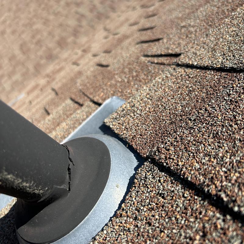Roof vent flashing with cracked rubber seal on shingles