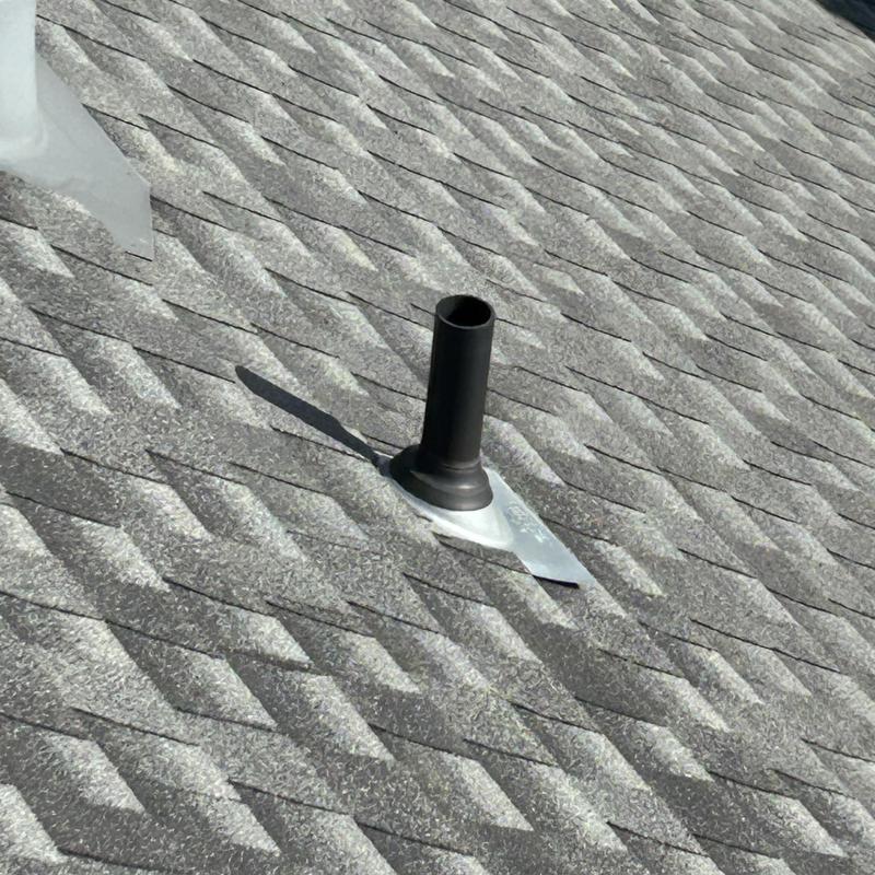 Roof vent pipe flashing on asphalt shingle roof
