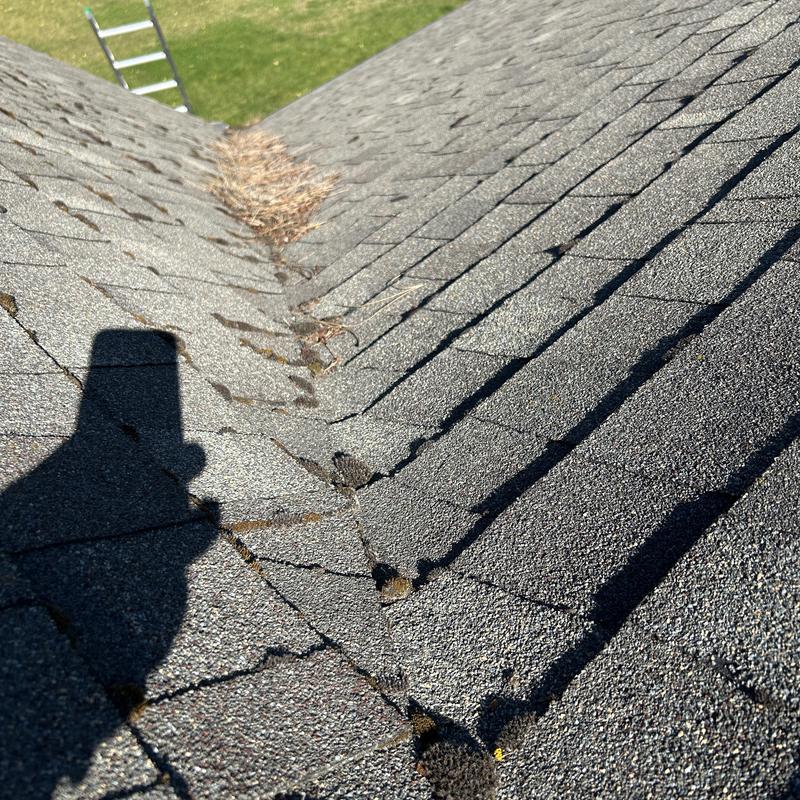 Asphalt shingle roof valley with granule loss and wear