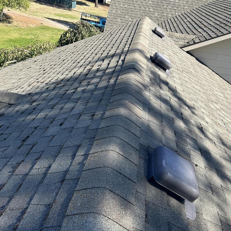Asphalt shingle roof with ridge vents and attic vents