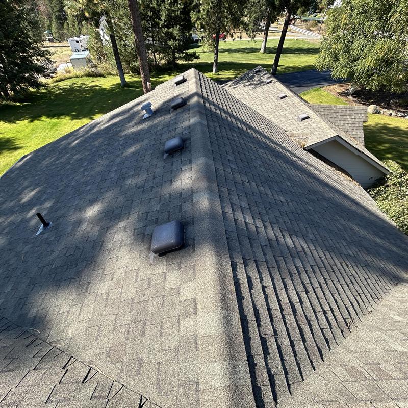 Asphalt shingle roof with vents and ridge cap installation