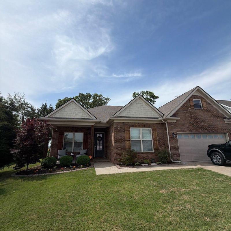 Roof shingles inspection for hail damage on brick house