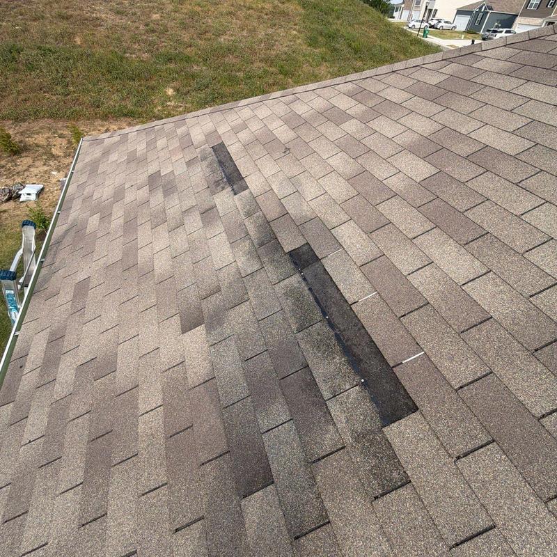 Asphalt shingles with storm damage and wear