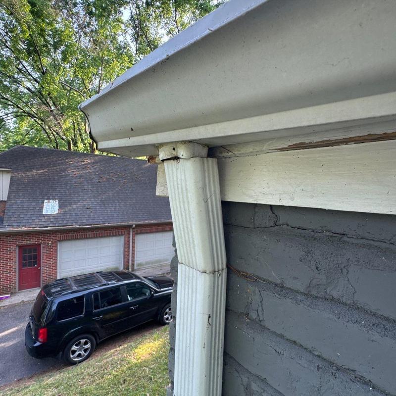 Gutter downspout disconnected from roof edge
