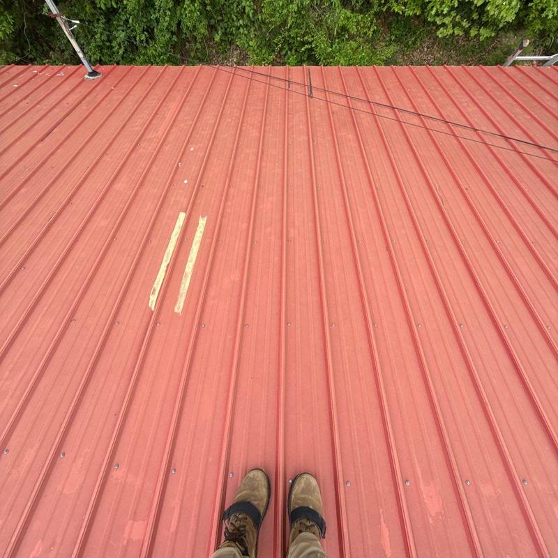 Metal roof panel with hail damage inspection marks