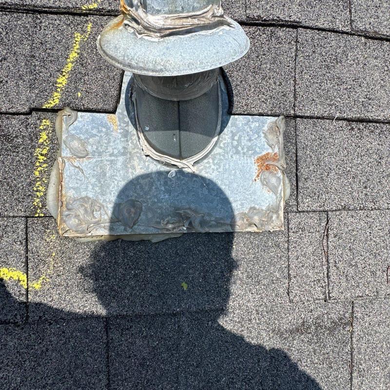 Metal roof vent flashing with weatherproof sealant and shingle damage