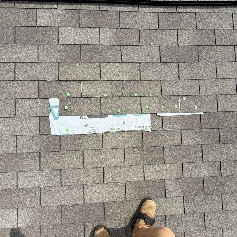 Roof shingles with hail damage markers and inspection tape