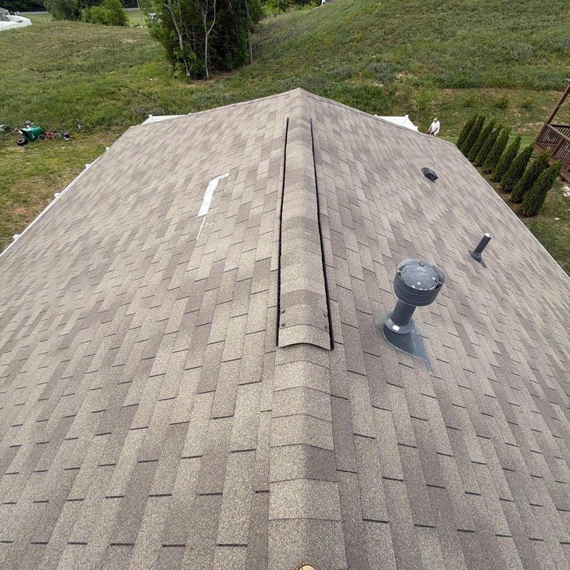 Asphalt shingle roof with vents and ridge cap