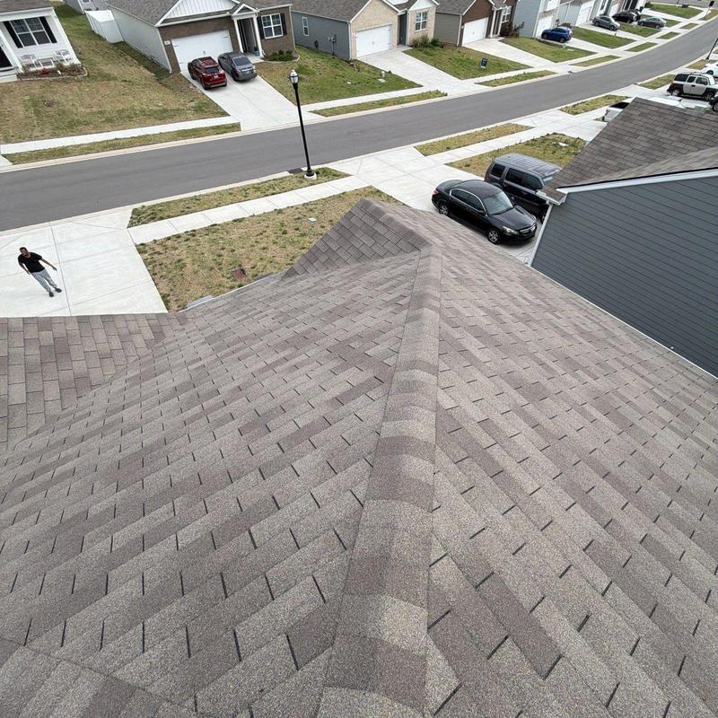 Asphalt shingle roof ridge and shingles inspection view
