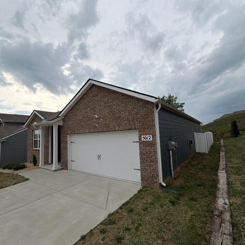 Garage door and brick exterior with concrete driveway