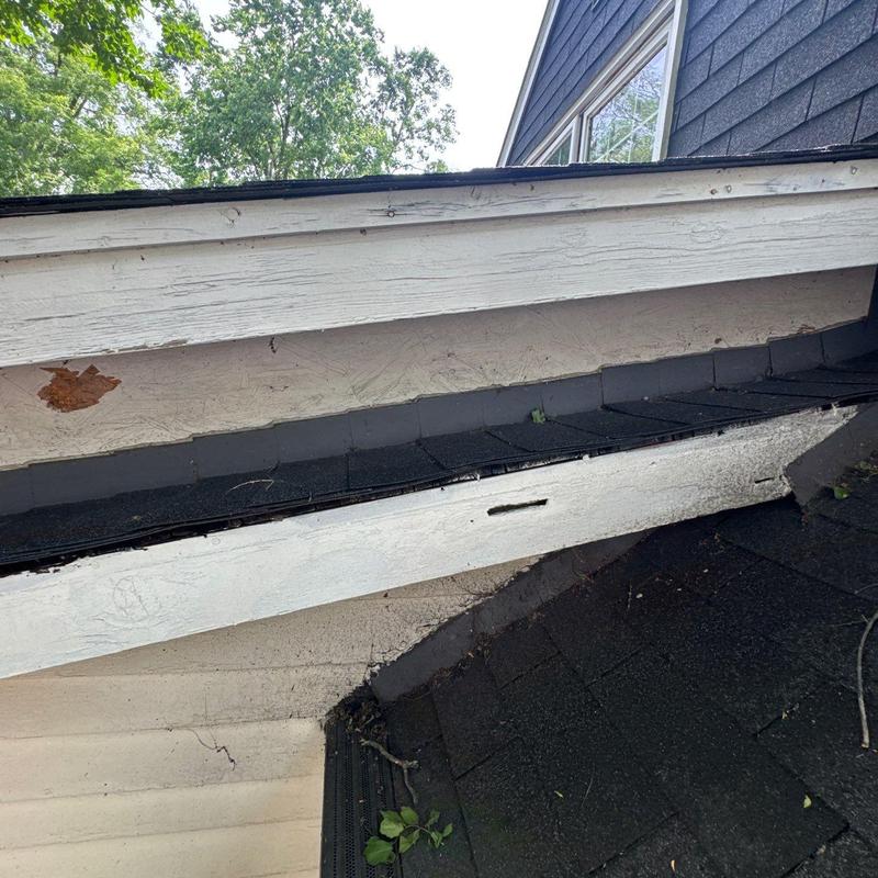 Roof fascia board with paint damage and wear