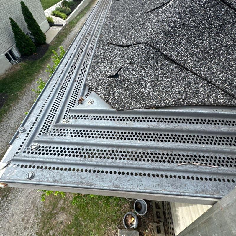 Roof edge metal drip edge with shingle damage