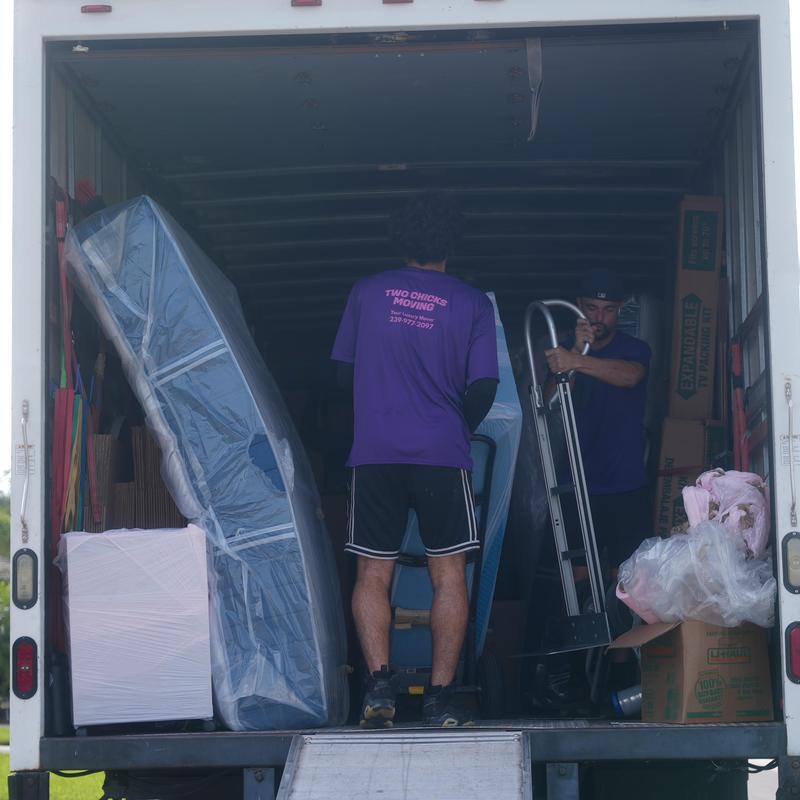 Mattresses and furniture loading inside moving truck