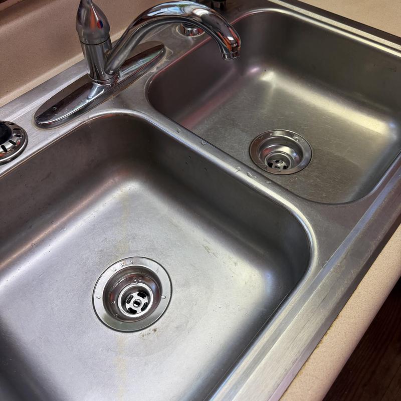 Double-basin stainless steel kitchen sink with faucet Double-basin stainless steel kitchen sink with faucet
