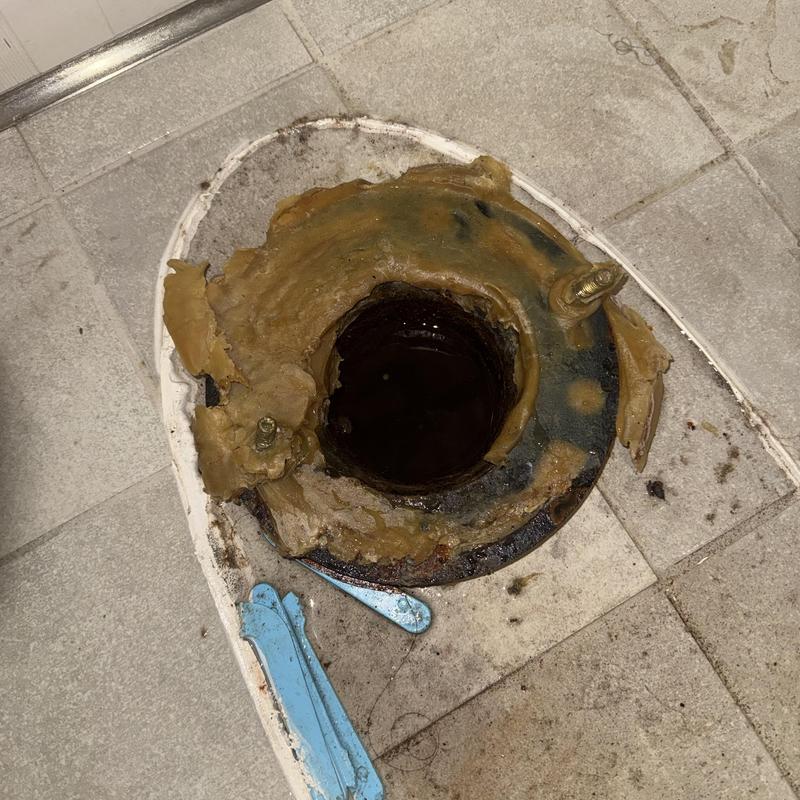 Toilet flange with wax ring residue on tiled floor Toilet flange with wax ring residue on tiled floor