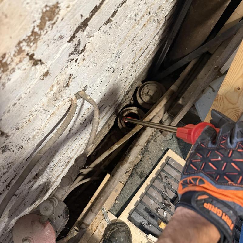 Sewer main line inspection with plumber tool in basement Sewer main line inspection with plumber tool in basement