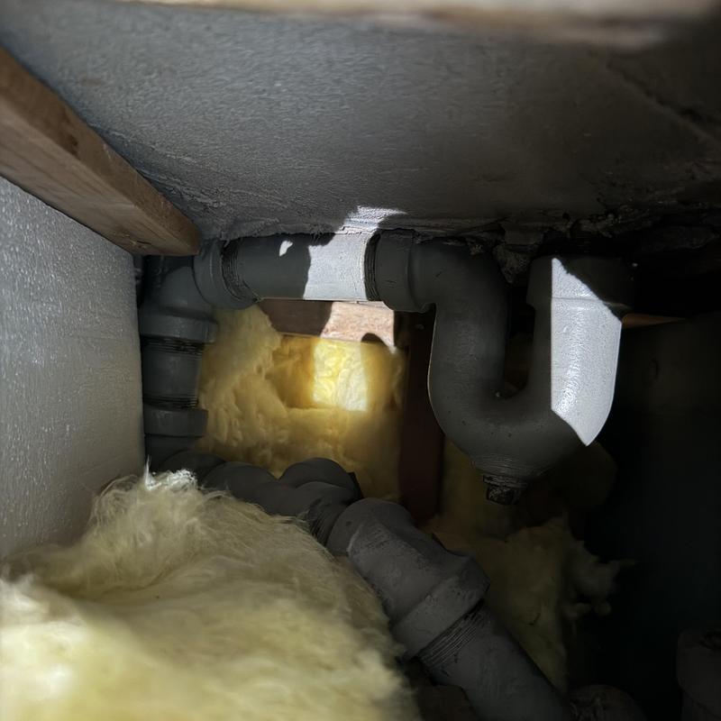 Bathroom secondary drain pipe with insulation surrounding Bathroom secondary drain pipe with insulation surrounding