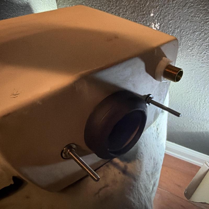 Toilet tank with mounting bolts and flush valve seal