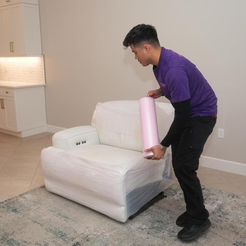 Leather armchair wrapped for moving with protective wrap