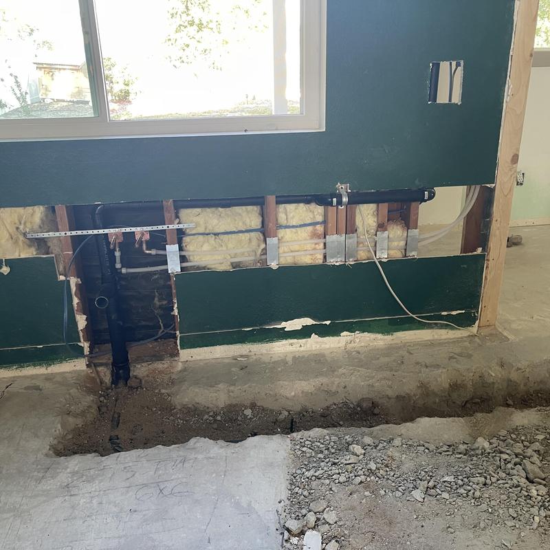 Kitchen drain line trench jackhammered under concrete floor