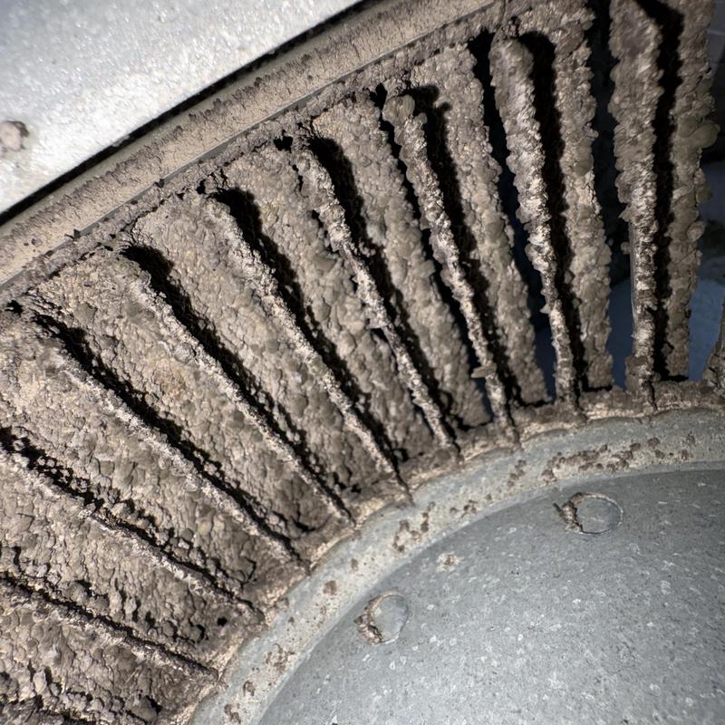 HVAC blower wheel heavily coated with dust buildup