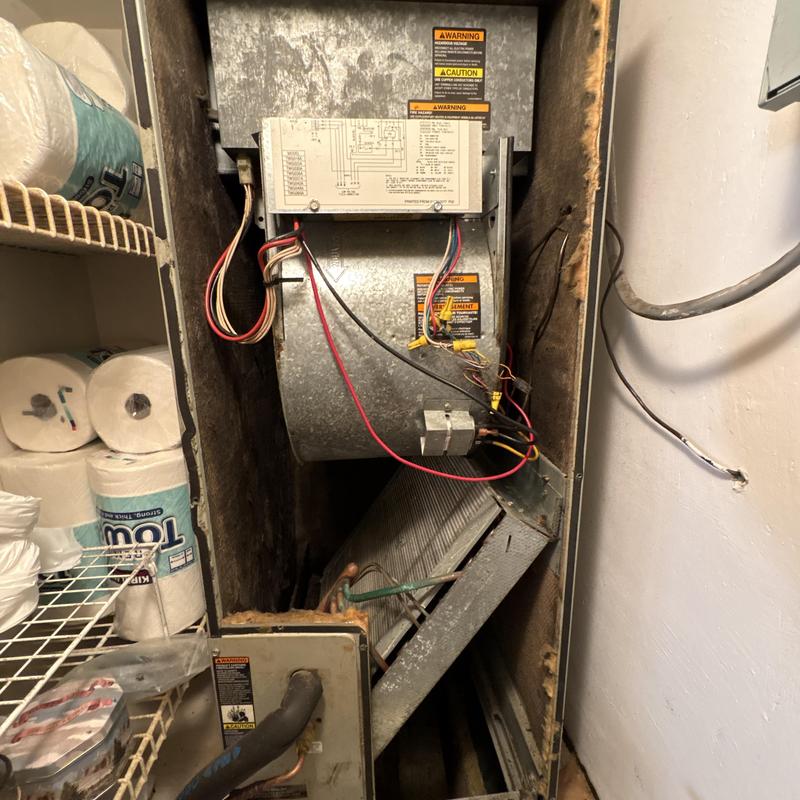 HVAC air handler unit with exposed wiring and coils