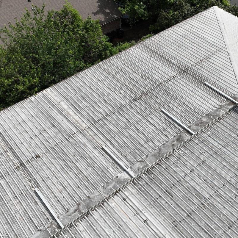 Metal roof panels with storm damage and repairs Metal roof panels with storm damage and repairs