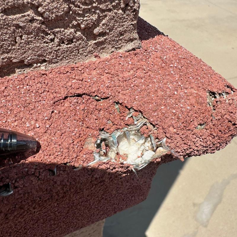 Spray foam roof damage with exposed fiberglass fibers Spray foam roof damage with exposed fiberglass fibers