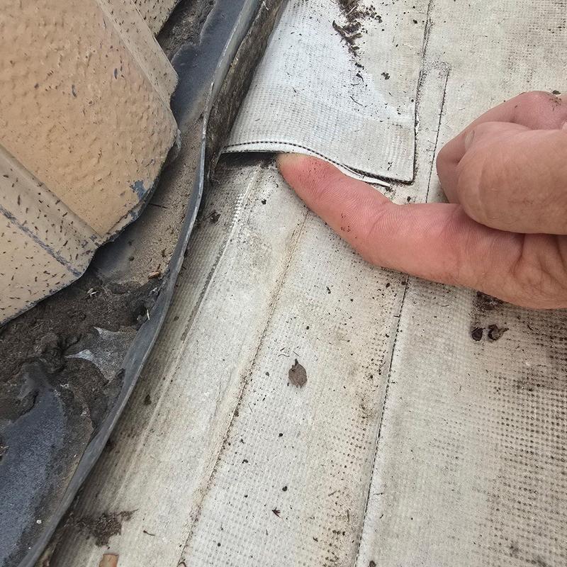 Concrete roof membrane with visible hail damage and dirt Concrete roof membrane with visible hail damage and dirt