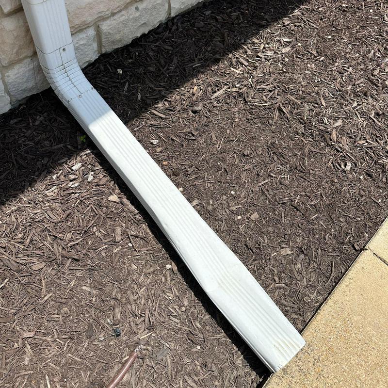 Gutter downspout extension directing water away Gutter downspout extension directing water away