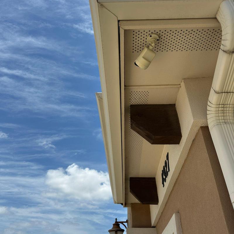 Gutter system with downspout and soffit vents under eave Gutter system with downspout and soffit vents under eave