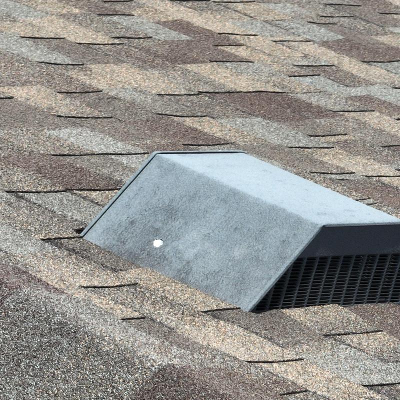 Roof vent with hail damage on shingled roof Roof vent with hail damage on shingled roof