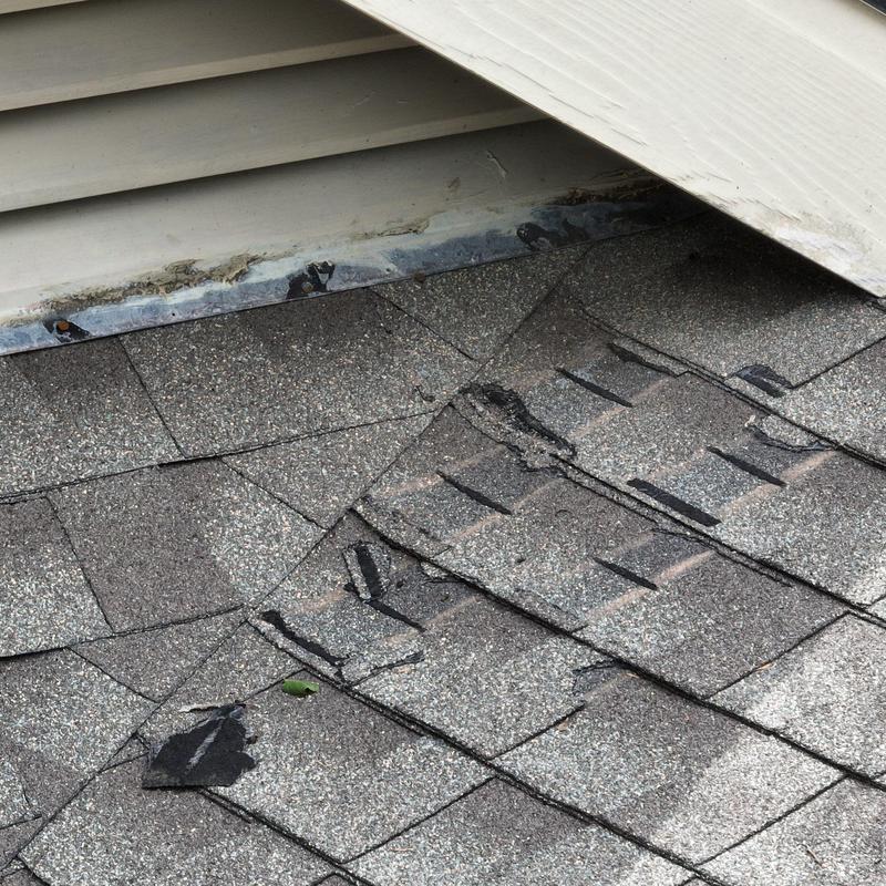 Shingle roof with hail damage near roof edge Shingle roof with hail damage near roof edge