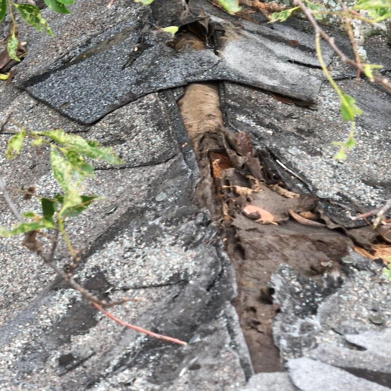 Shingle roof with weathered and damaged flashing exposed Shingle roof with weathered and damaged flashing exposed