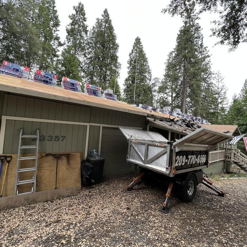 GAF asphalt shingles stacked on cabin roof deck