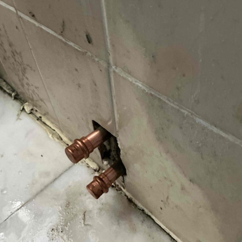 Copper bidet water supply lines capped behind tile wall