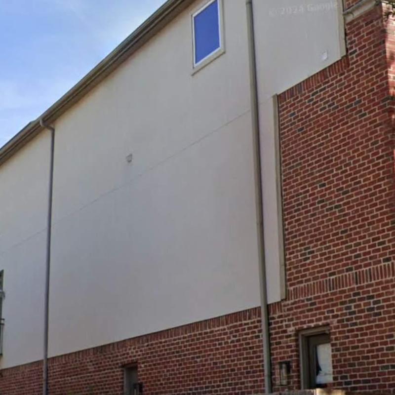 Stucco wall exterior with brick base and window Stucco wall exterior with brick base and window