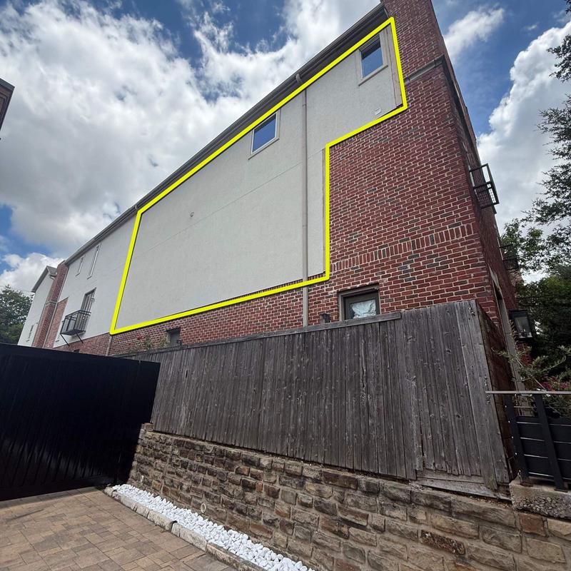 Stucco wall repair outline on brick building exterior Stucco wall repair outline on brick building exterior