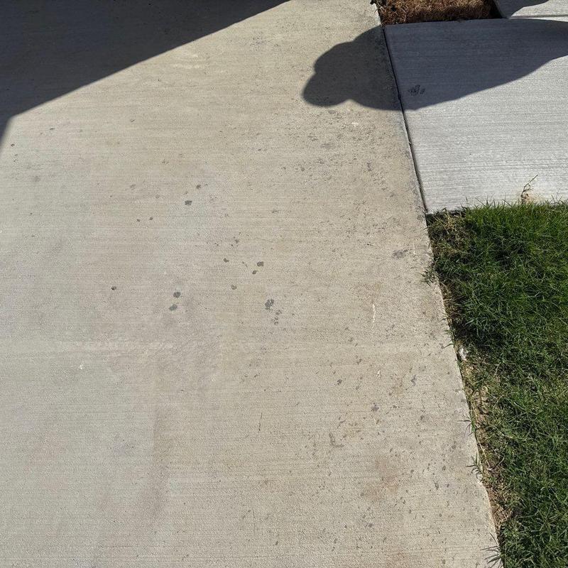 Concrete driveway cleaning with dirt and grass edges Concrete driveway cleaning with dirt and grass edges