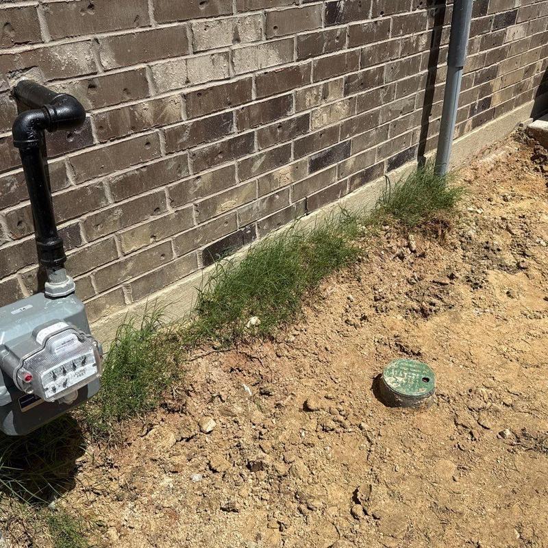 Gas meter and brick exterior with disturbed soil nearby Gas meter and brick exterior with disturbed soil nearby
